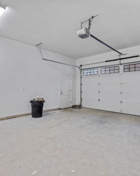 Empty white garage with windows